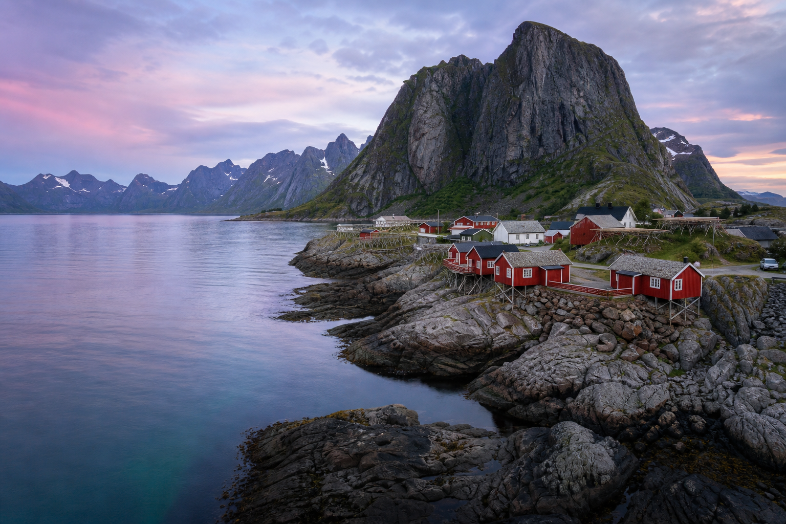 The Lofoten Islands Norway, dramatic sharp peaks rising from cold turquoise fjord water, traditional red fishing cabins, soft Arctic evening light, real photograph, landscape photography